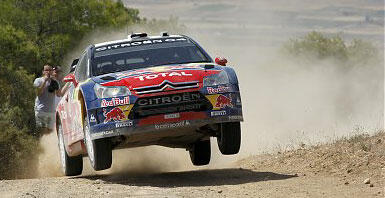 En rallybil hoppar över en grusväg. (AI text)