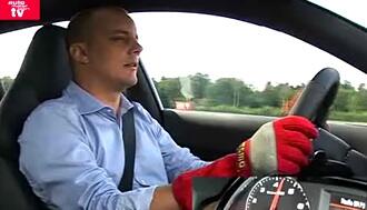 En man i en röd jacka kör en bil. (AI text)