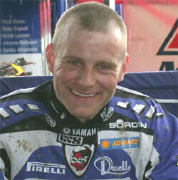 En man med en motorcykelhjälm leende (AI text)