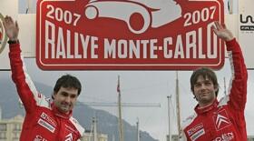 Två personer står på en rally-scen. (AI text)