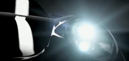 En svart sportbil med tändningsljus på. (AI text)