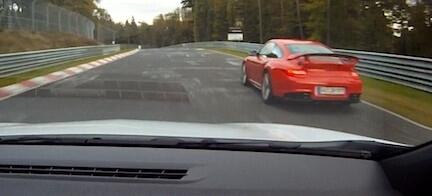 En röd Porsche 911 GTS kör nerför en racerbana. (AI text)
