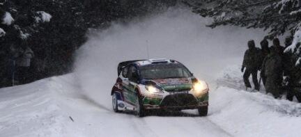 en rallybil körande längs en snöig väg (AI text)
