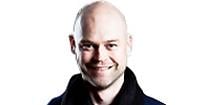 En man med glatt leende, utan hår. (AI text)