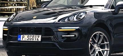 En svart Porsche Macan parkerad på en gata. (AI text)