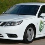 En vit bil kör ner en väg. (AI text)