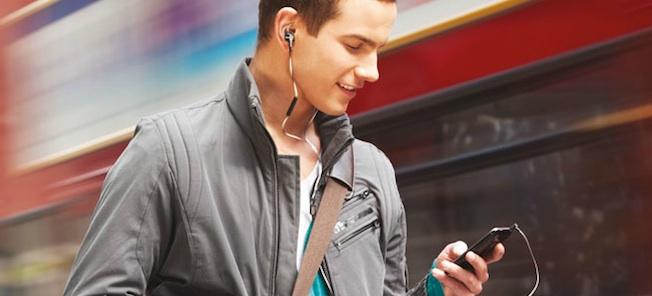 En man lyssnar på musik samtidigt som han går nära en järnväg. (AI text)