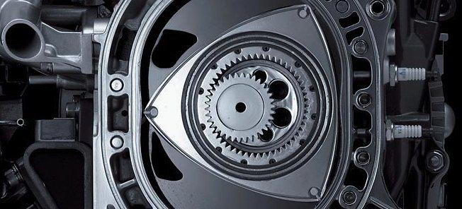 En bensinmotor med växellåda på en svart bakgrund. (AI text)