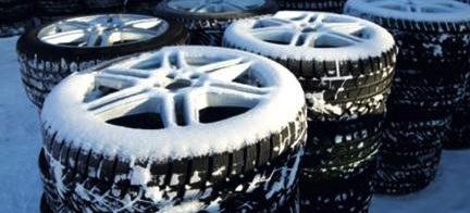 En grupp däck staplade i snön (AI text)