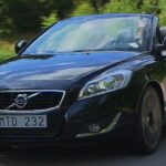 En Volvo C40 cabriolejon ner en landsväg. (AI text)