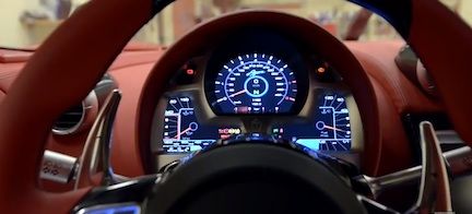 en röd sportbil med en instrumentbräda och ratt (AI text)