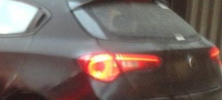 En svart bil står parkerad i en parkeringsplats. (AI text)