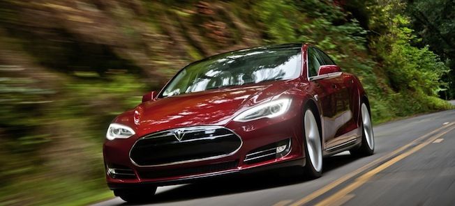 En Tesla Model S kör nerför en väg. (AI text)