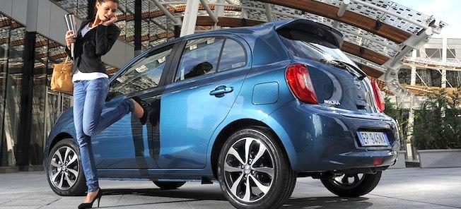 En kvinna står bredvid en blå bil. (AI text)