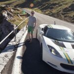 En vit sportbil på en bergväg. (AI text)