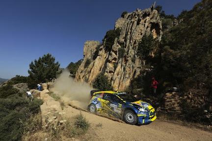 En rallybil körer längs en grusväg. (AI text)