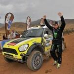 En man står bredvid en Mini Countryman. (AI text)