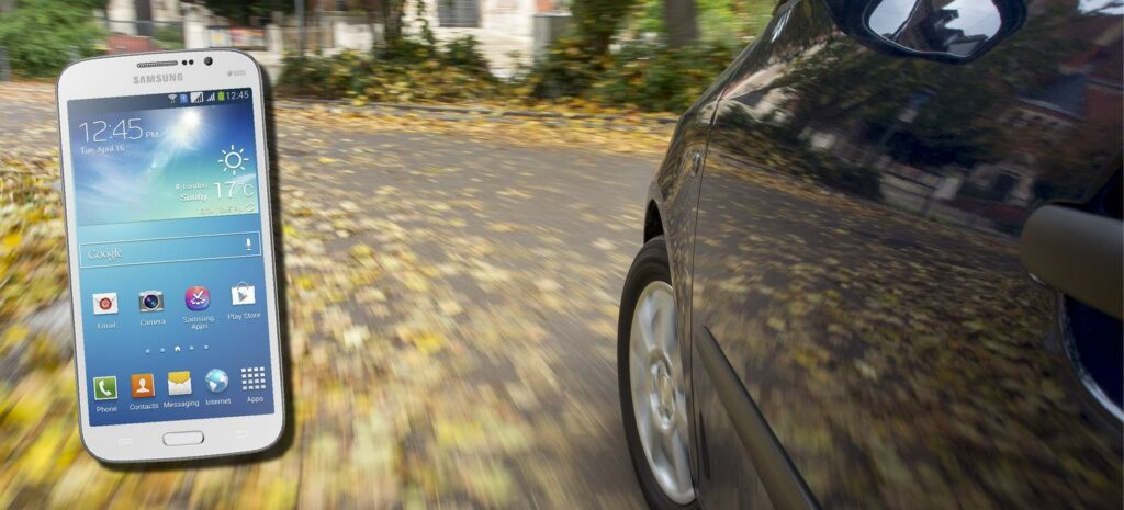 En bil med en mobiltelefon på vindrutan. (AI text)