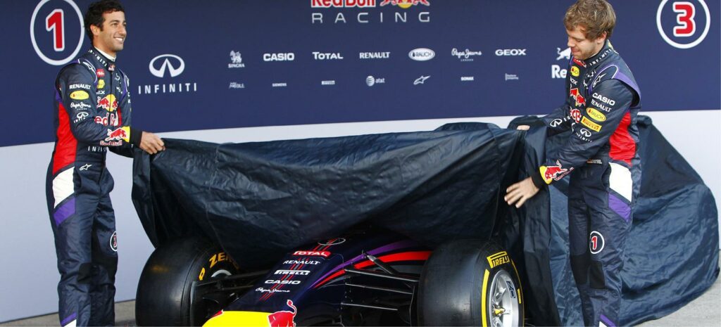 Två Red Bull-racingförare står bredvid en bil. (AI text)