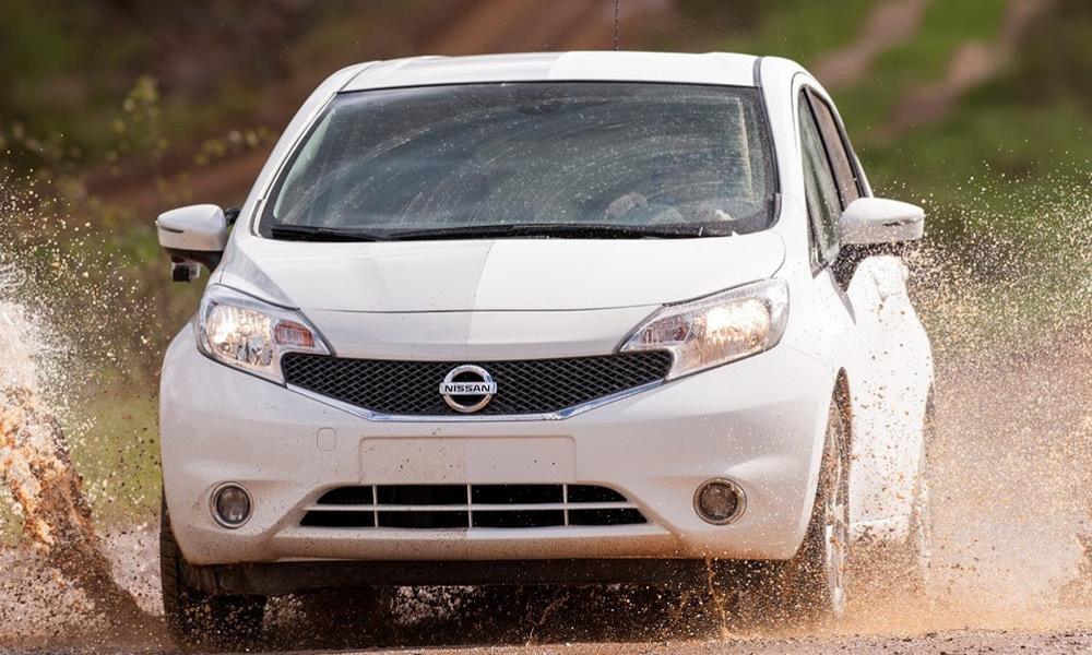 En vit bil kör genom en smutsig yta. (AI text)