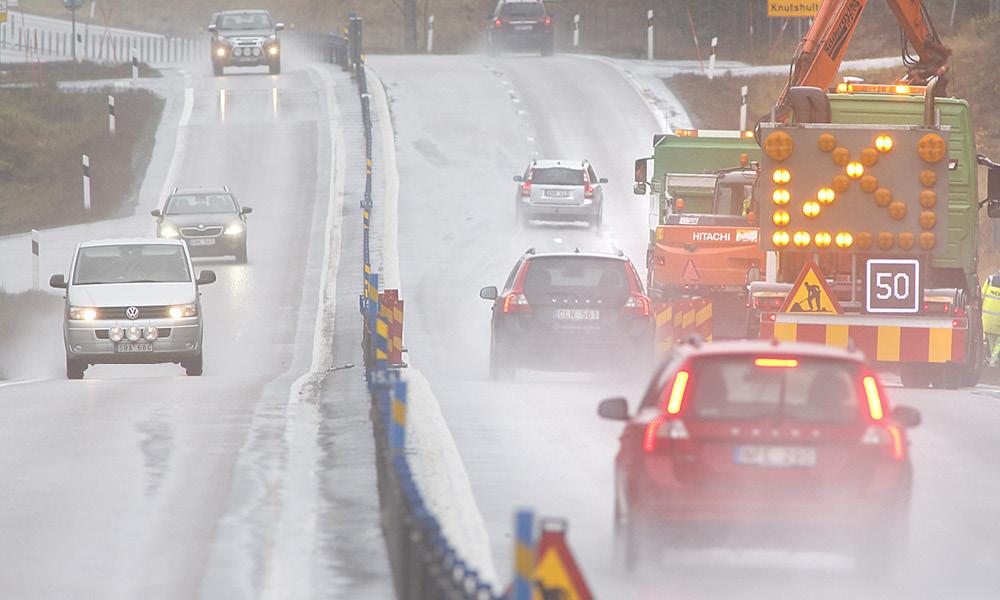 En bil körer nedför en snötäckt väg. (AI text)