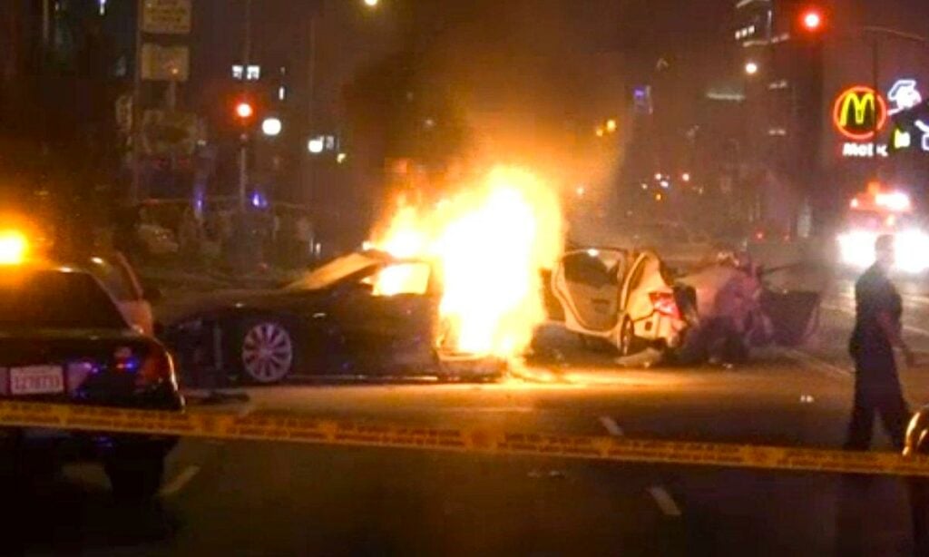 En bil brinner i en stad. (AI text)