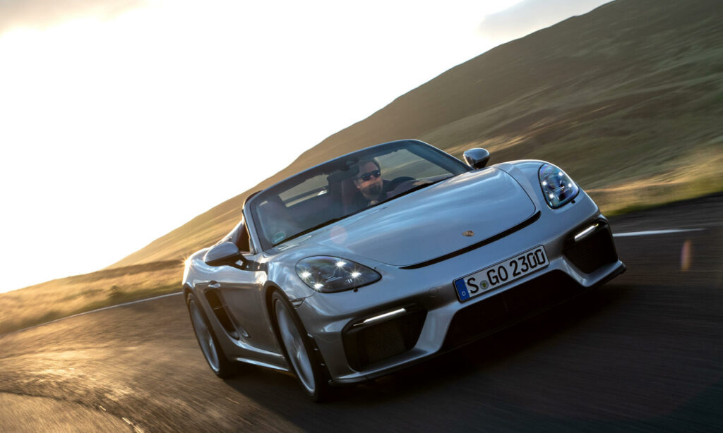 En Porsche Boxster kör nerför en bergväg. (AI text)