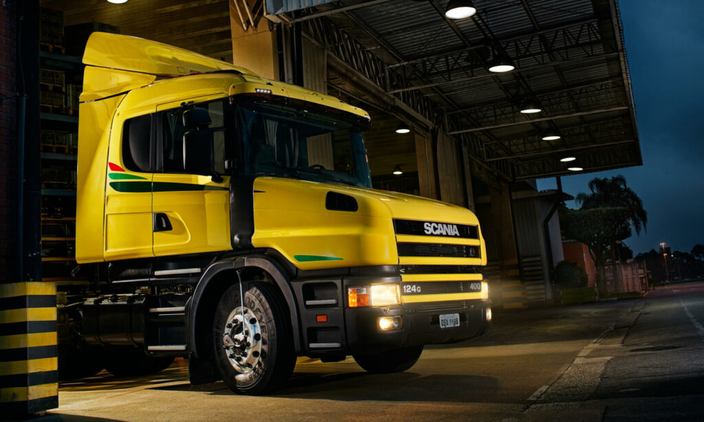 En gul lastbil står parkerad i garaget. (AI text)