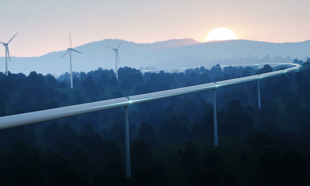 En vindkraftverk syns i fjärran. (AI text)