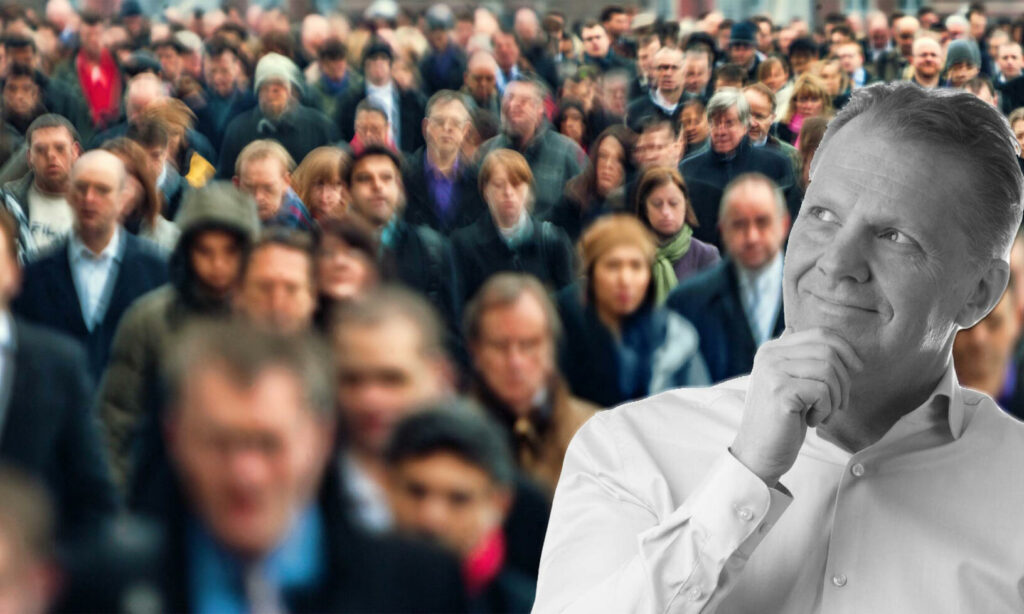 En man står framför en skara folk. (AI text)