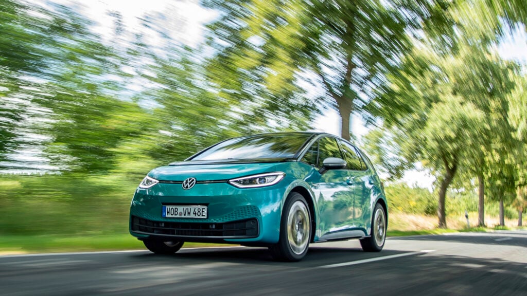 En blå Volkswagen ID kör nerför en landsväg. (AI text)