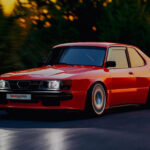 En röd BMW E30 kör nerför en väg vid solnedgången. (AI text)