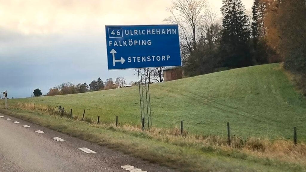 En vägmärkes platta med texten 'Norge' (AI text)