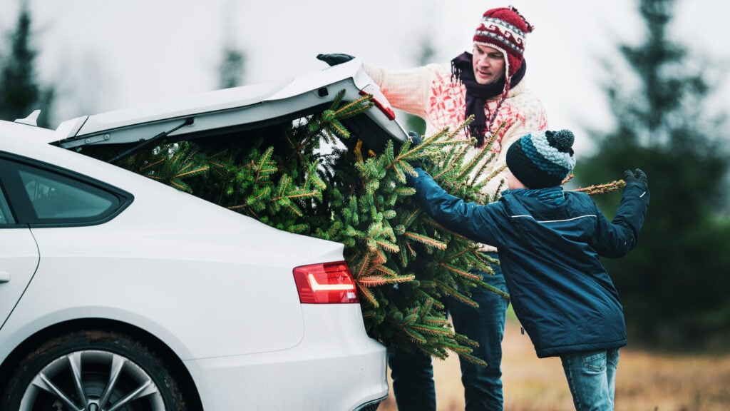 En familj laddar på julen och lastar in julkalenderna i sin bil. (AI text)