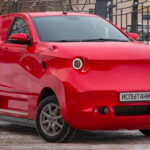 En röd bil parkerad i snön (AI text)