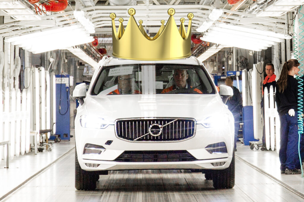 En bil med en krans på den i en fabrik. (AI text)