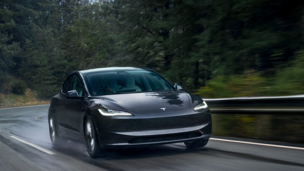 En Tesla Model 3 kör längs en väg. (AI text)