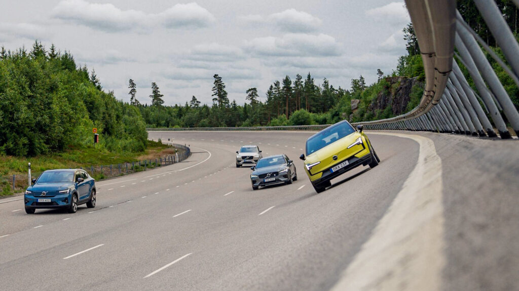 Testbana med fyra Volvo-bilar körandes på en bankad del av banan.