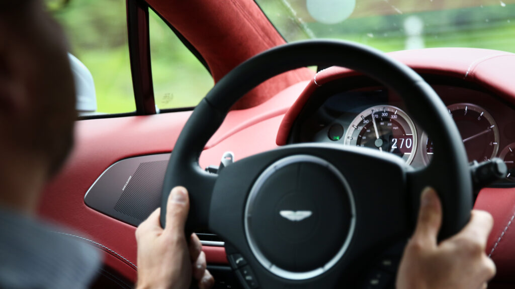 En man kör en röd sportbil. (AI text)