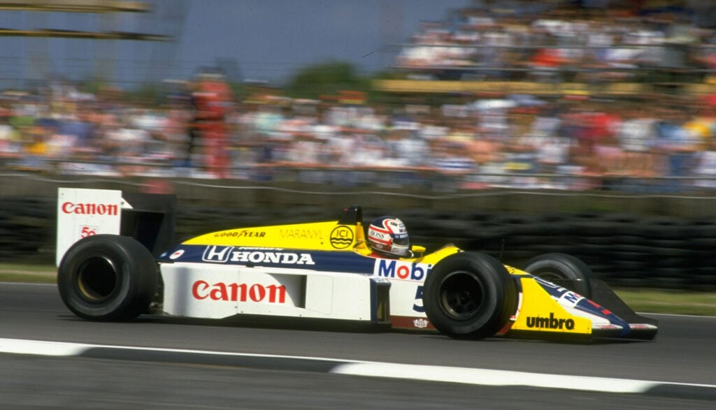 person driving a Renault TT F1 car at the British Grand Prix (AI text)