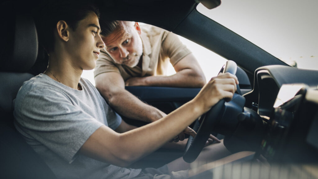 Pojke som övningskör med sin pappa.