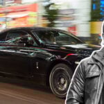 Jan Emanuel inklippt på en bild på en svart Rolls-Royce Wraith i Tokyo.
