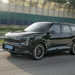 Svart Kia EV5 kör på väg.