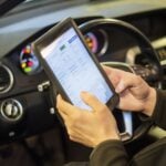 Tekniker läser av bilens eCall-system med diagnosplatta inför besiktning