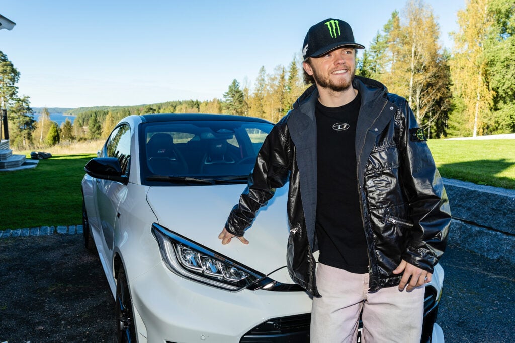 Oliver Solberg utanför sitt hem med en vit Toyota GR Yaris.