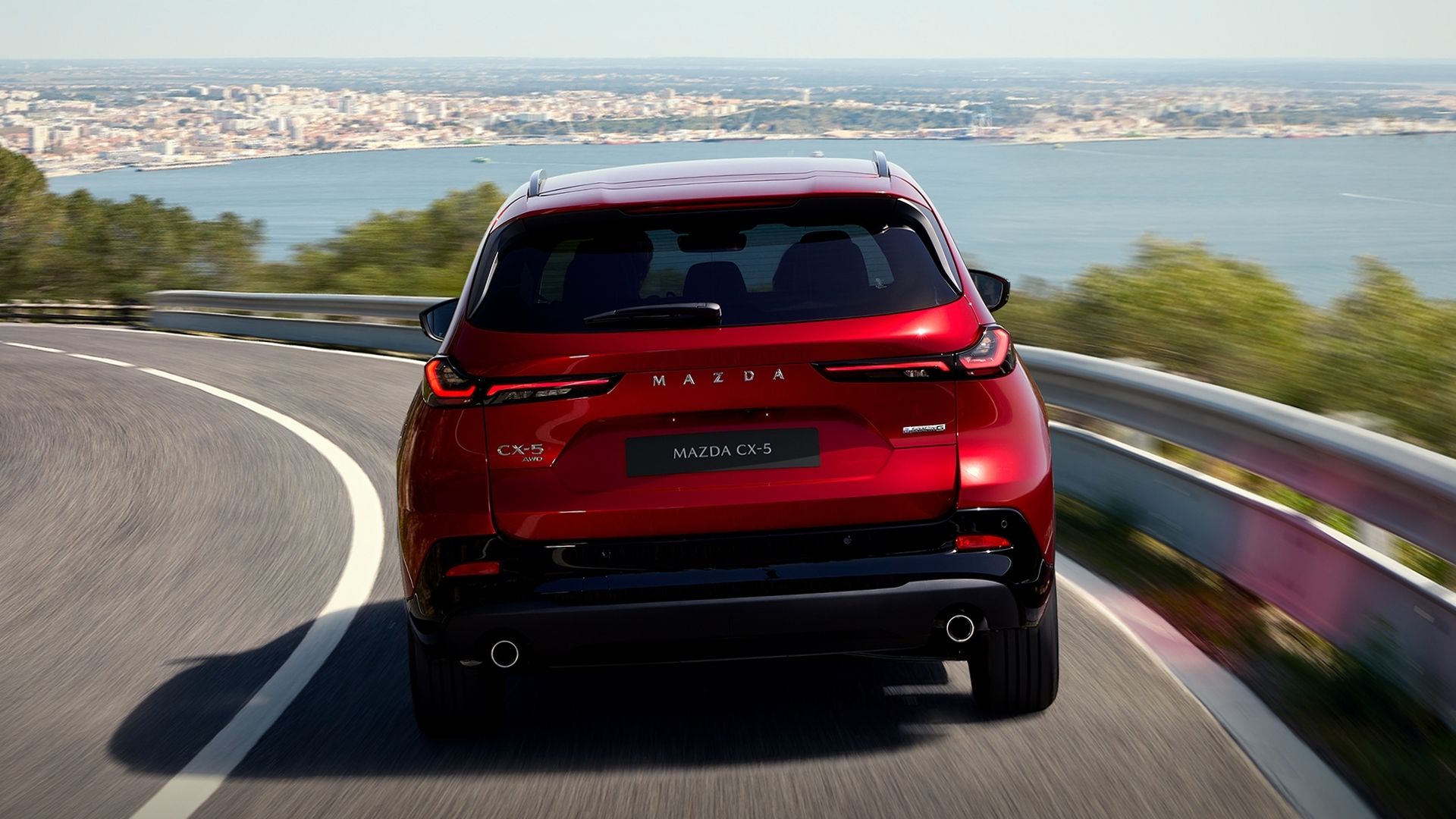 Mazda CX-5 2026 sedd bakifrån på kurvig väg