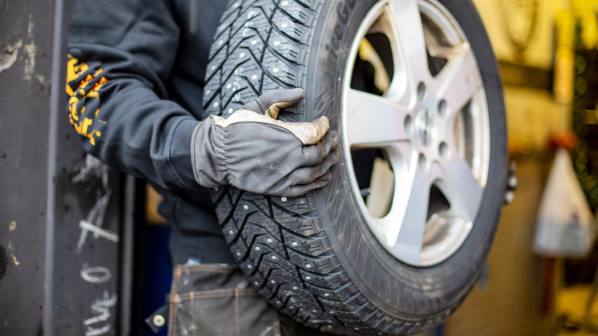 Närbild på dubbdäck i händer på en mekaniker.