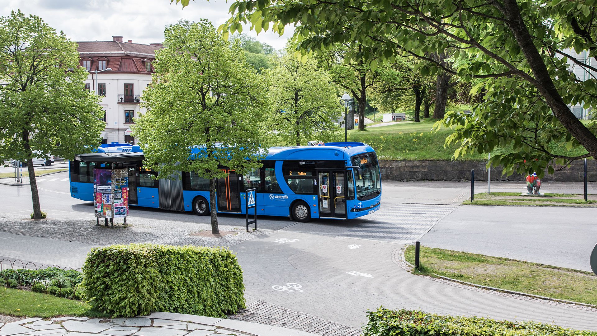 Blå buss från Västtrafik kör på väg.
