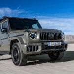 Grön Mercedes-Benz G-klass snett framifrån kör i öknen.
