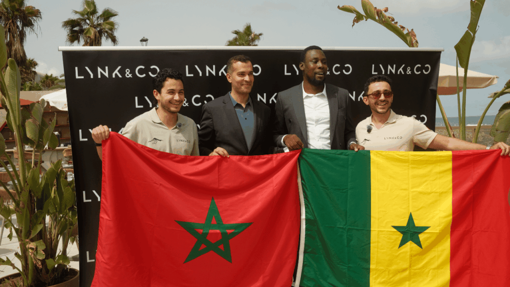Företrädare för Lynk & Co håller stolt upp Marockos och Senegals flaggor för att markera resans start och slutpunkt. Foto: Lynk & Co